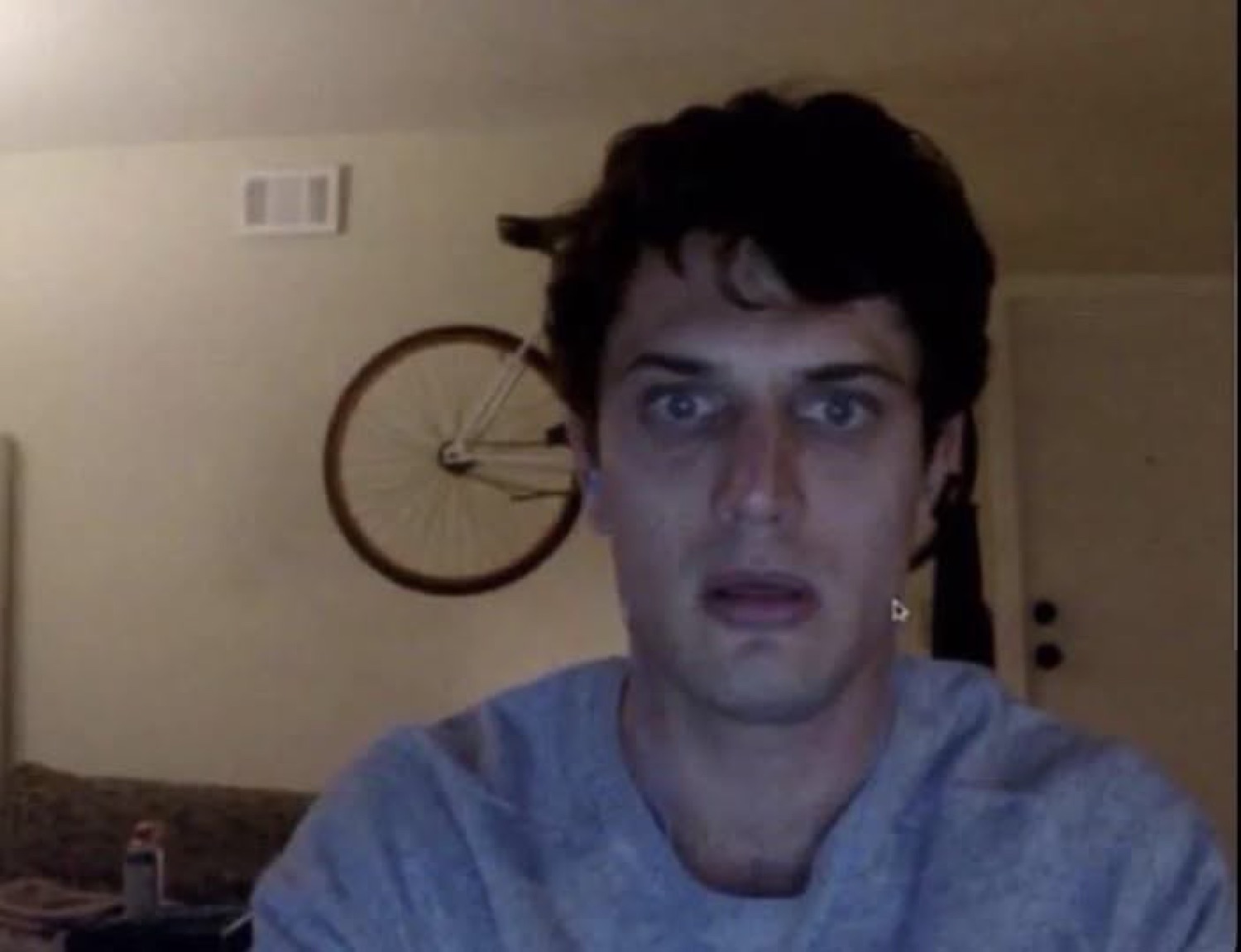 Guy on a dim webcam with a slack-jawed, wide-eyed stunned look