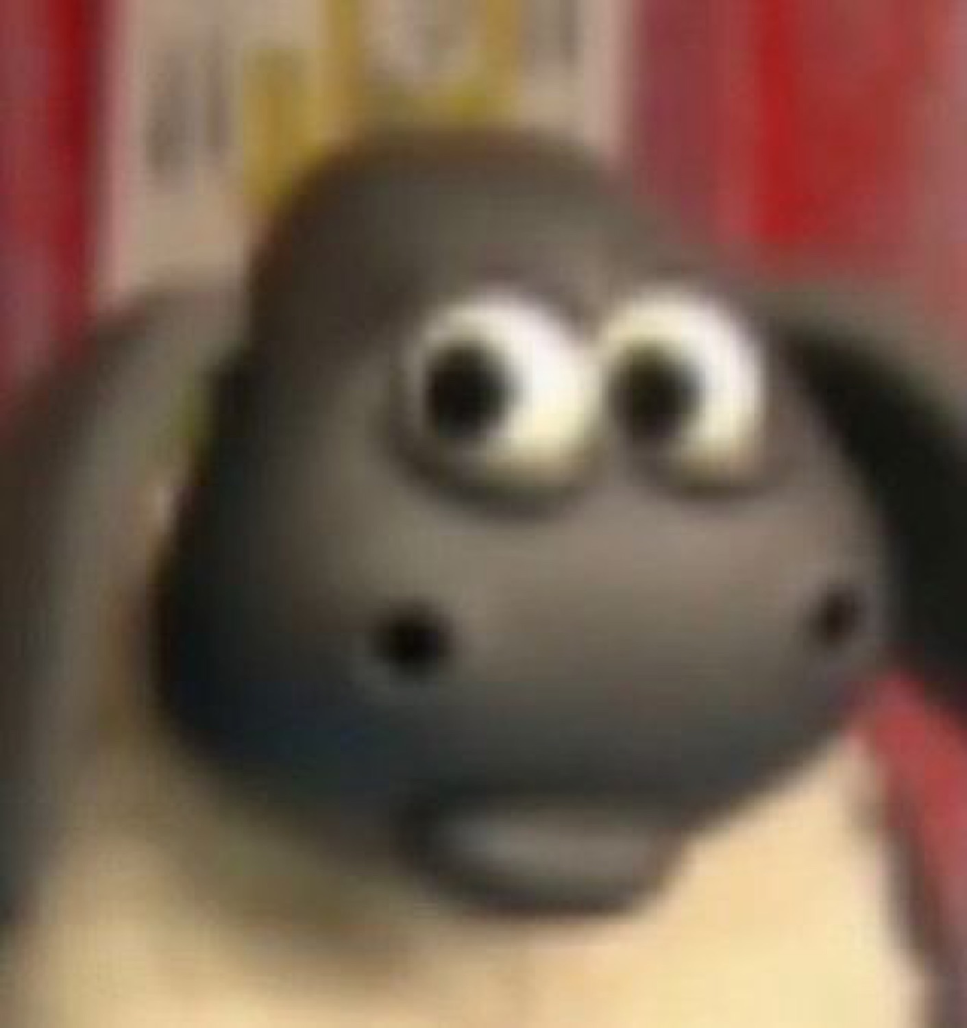 Shaun the Sheep staring wide-eyed directly at you with complete alarm