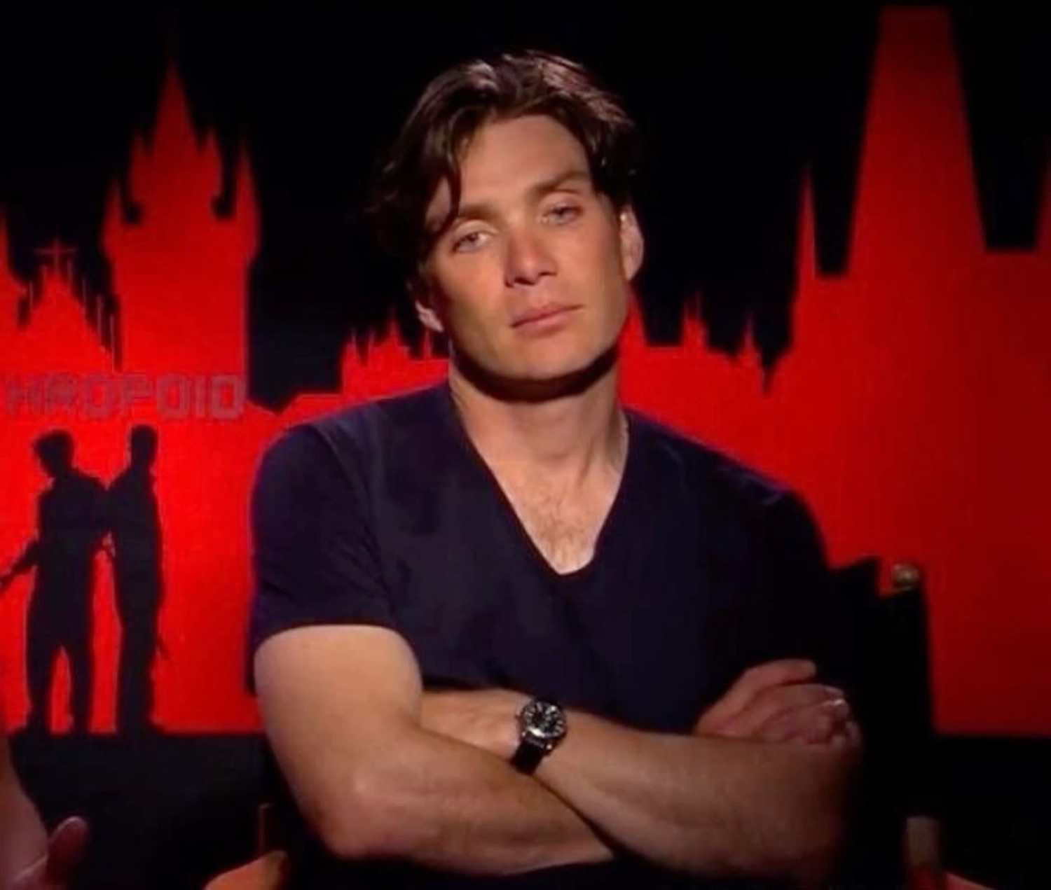 Cillian Murphy with arms crossed and a withering stare, completely done with the situation