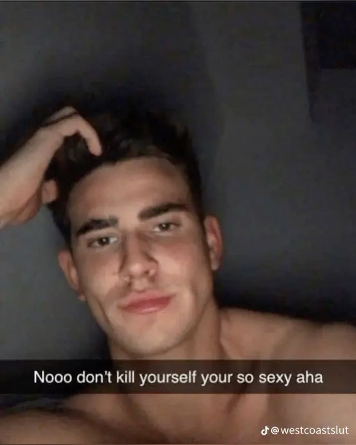 Shirtless guy in bed giving a smug look, captioned 'Nooo don't kill yourself your so sexy aha'