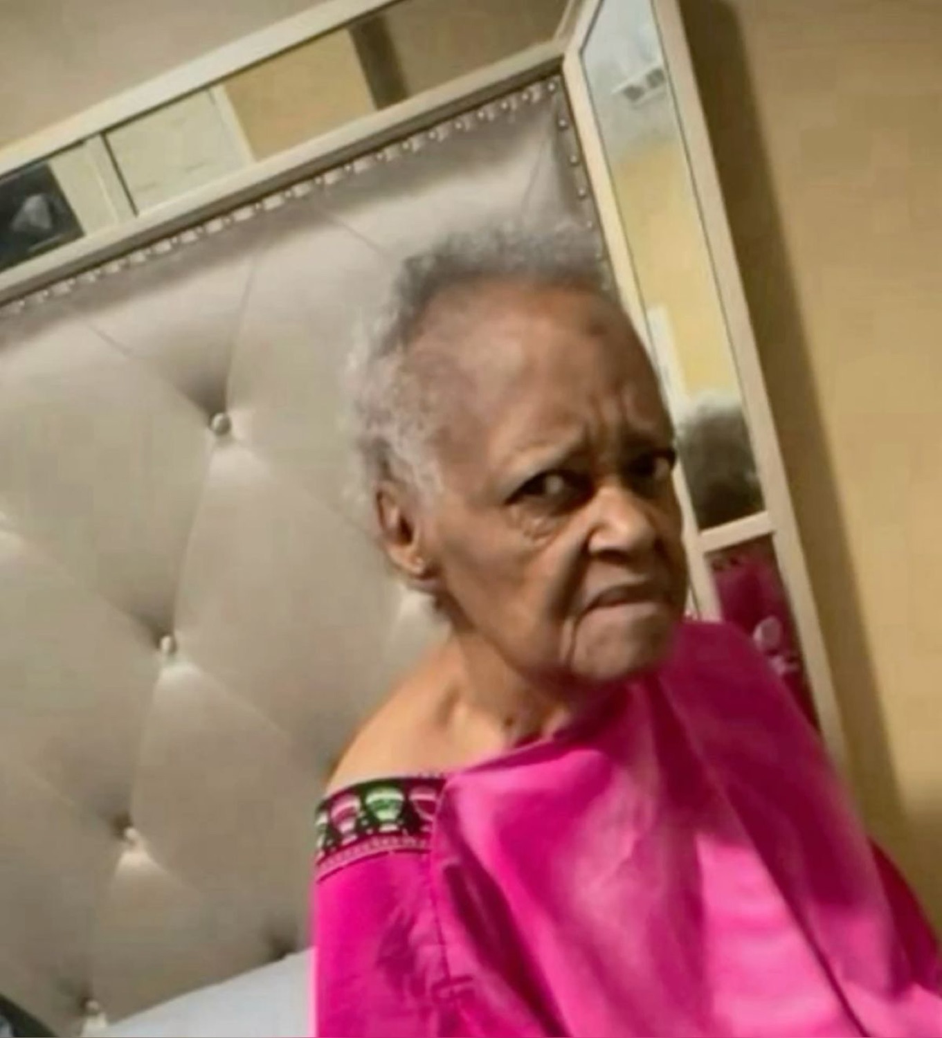 Grandma in a pink cape giving a hard side-eye