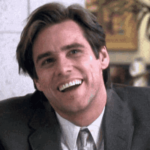 Jim Carrey in a suit shaking his head, "No"