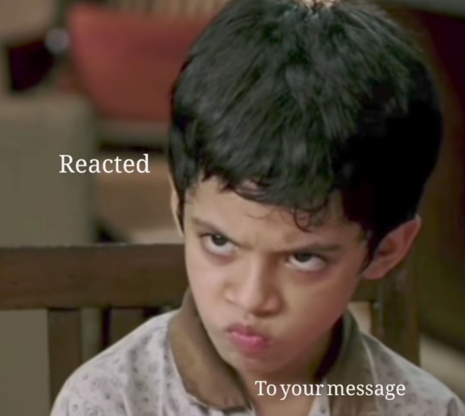 Boy glaring up angrily with 'Reacted to your message' text