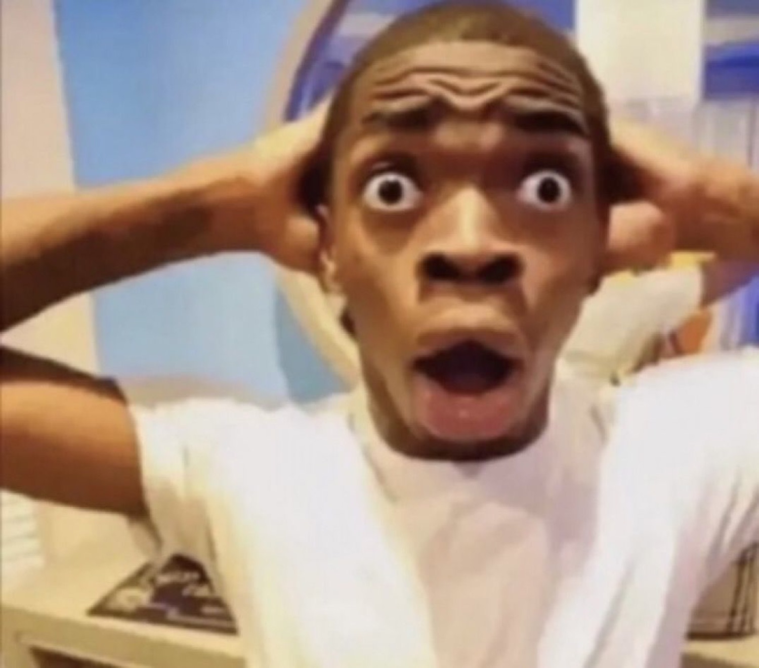 Man gripping his head with bulging eyes and open mouth in total shock