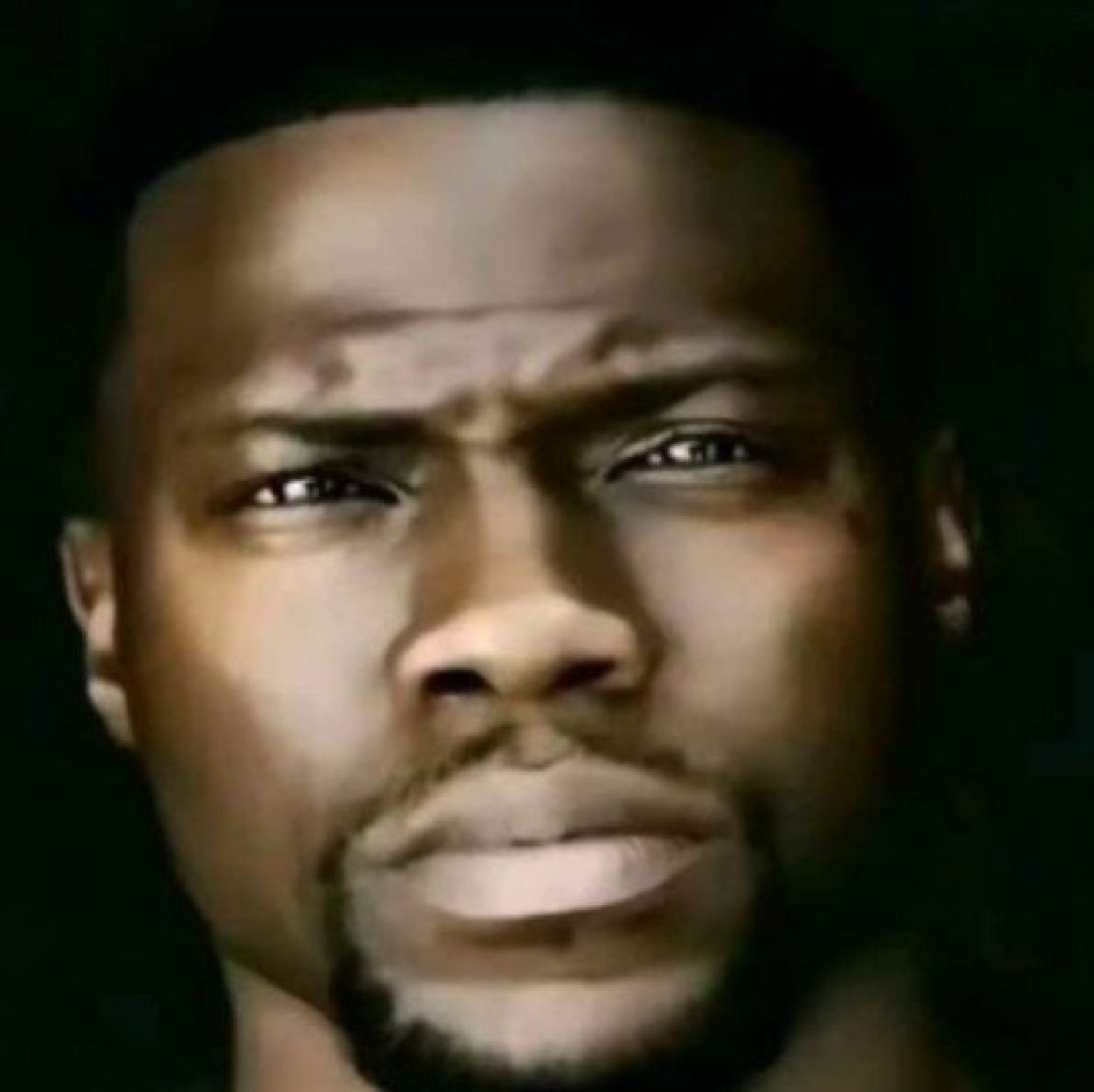 Kevin Hart staring down the camera with a flat, deeply unimpressed glare