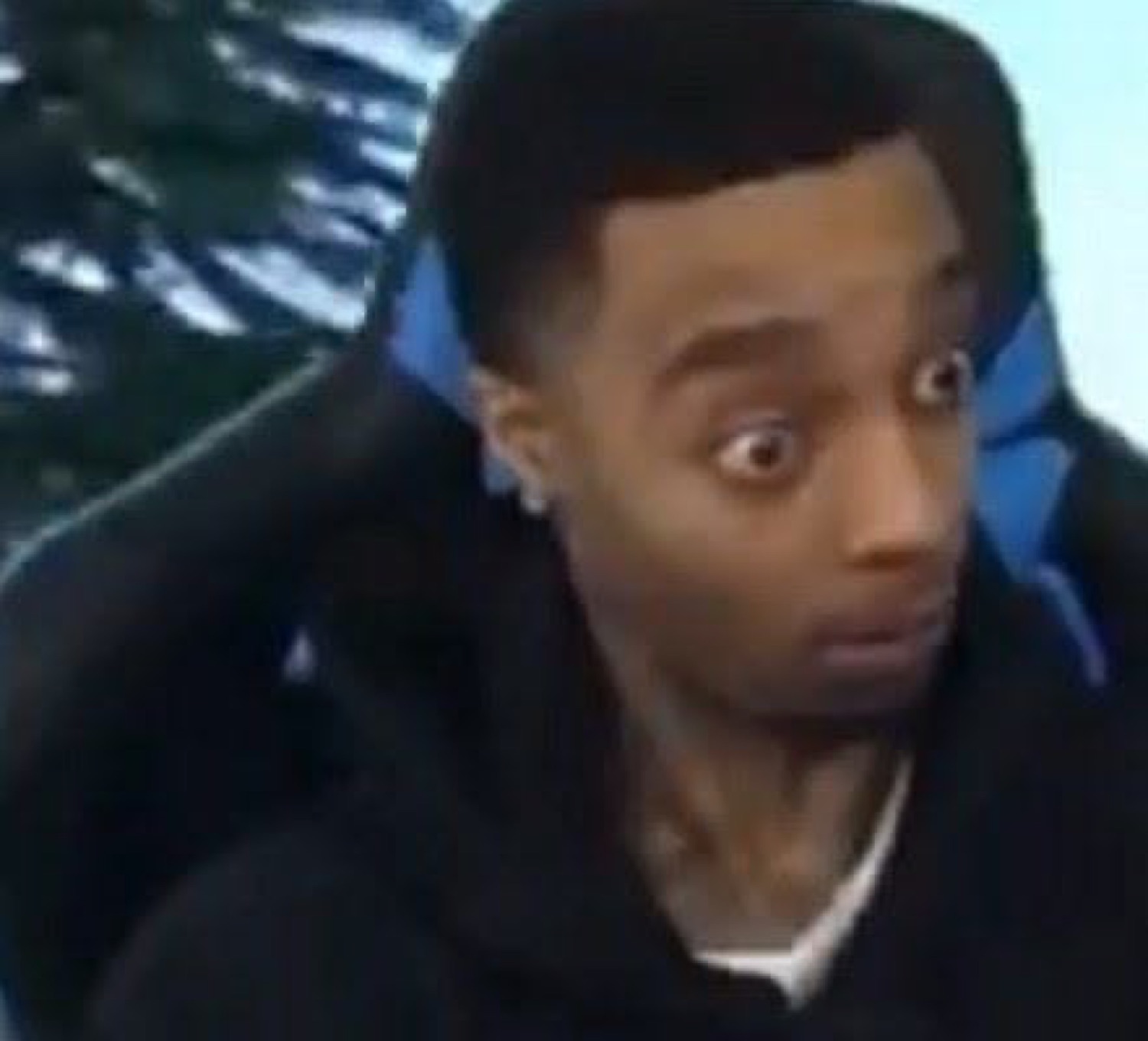 Man in a gaming chair with bulging wide eyes, totally stunned