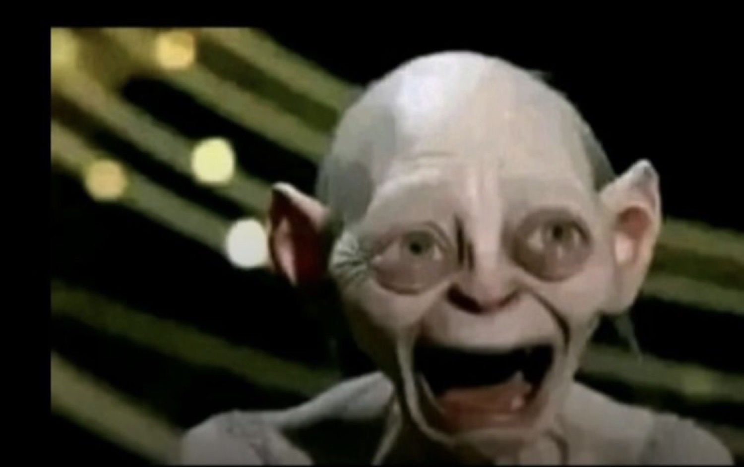 Gollum with eyes and mouth stretched wide in a manic, over-excited scream