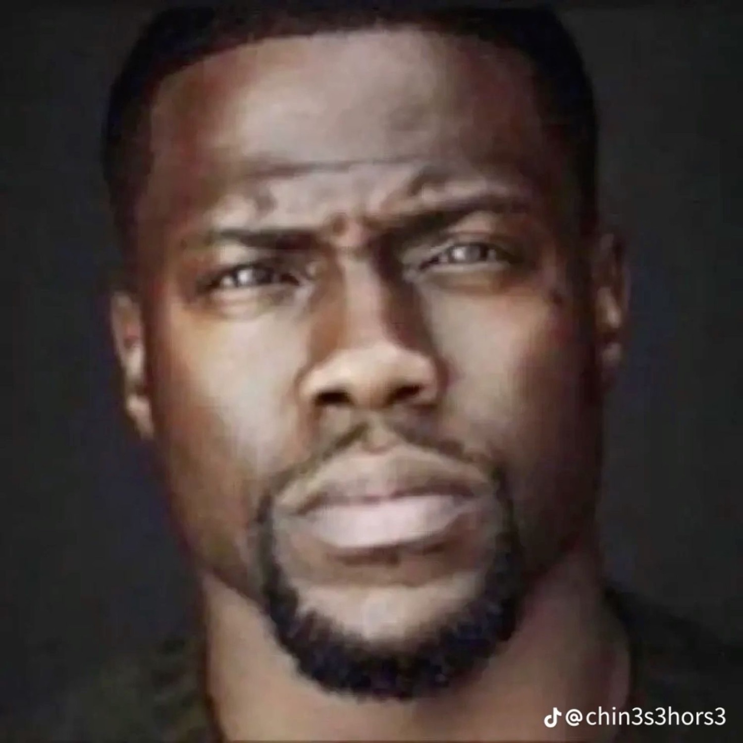 Kevin Hart staring straight ahead with intense narrowed eyes and a stone-cold expression