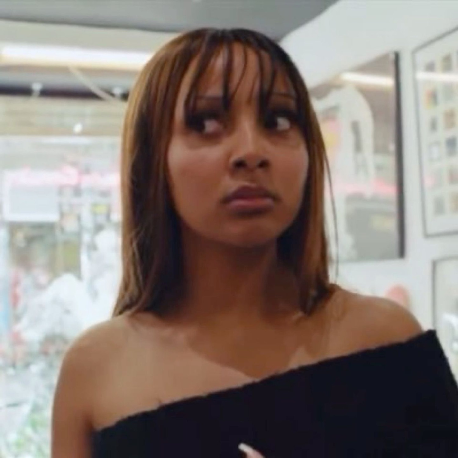 Woman glancing off to the side with a suspicious, unimpressed side-eye