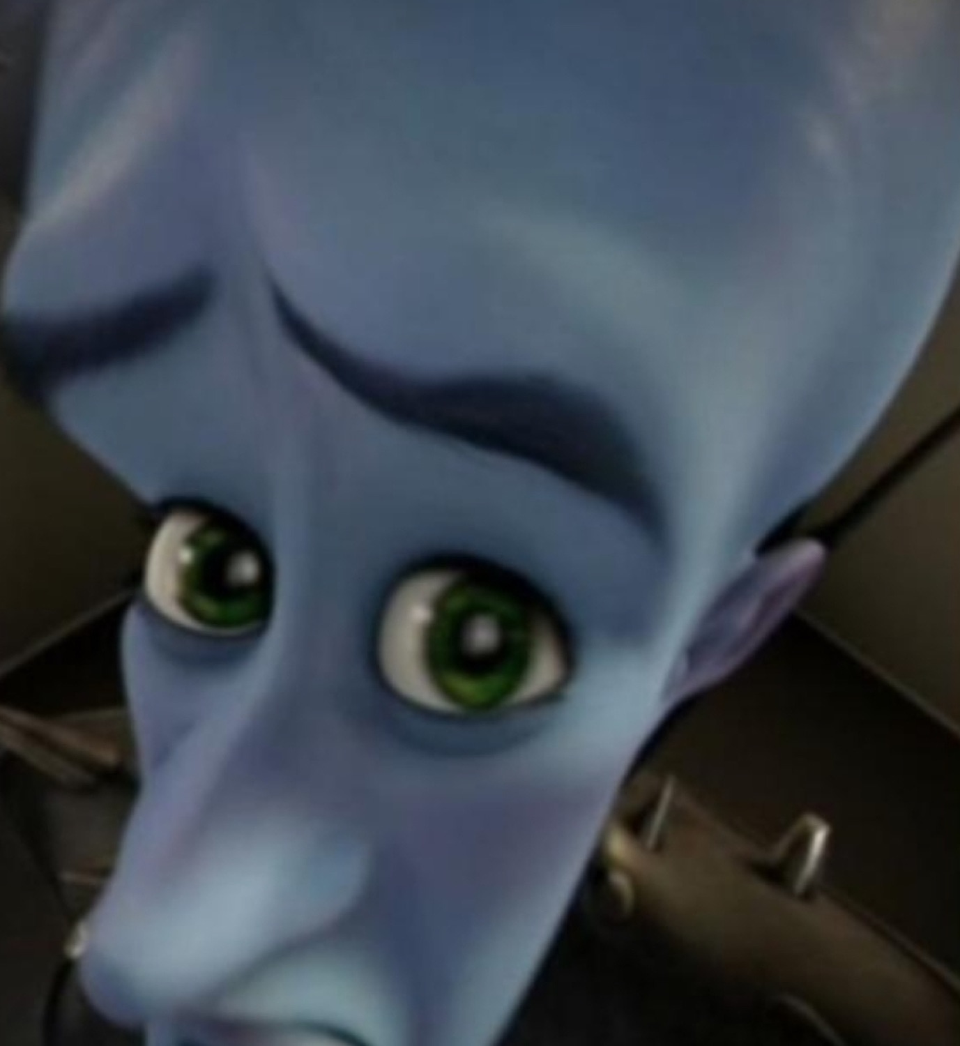 Megamind tilting his big blue head forward with wide green eyes in disbelief