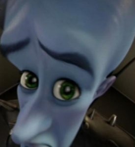 Megamind tilting his big blue head forward with wide green eyes in disbelief