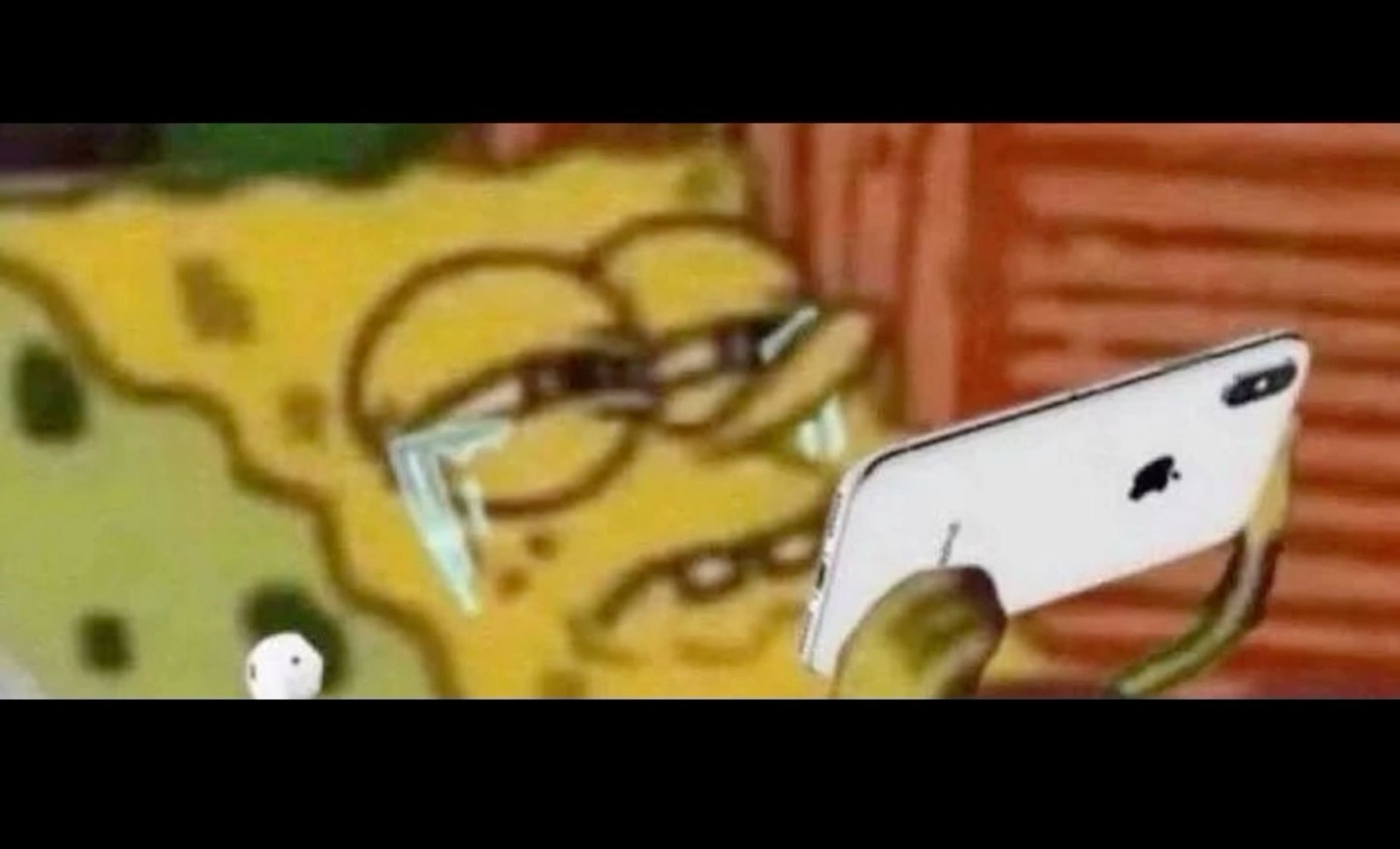 SpongeBob squinting through thick glasses held right up to his face