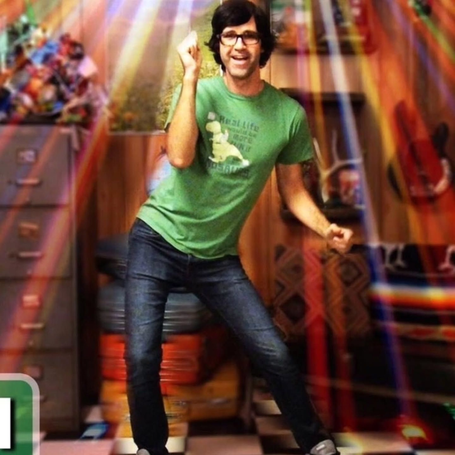 Guy in a green tee doing an enthusiastic finger-snap dance move