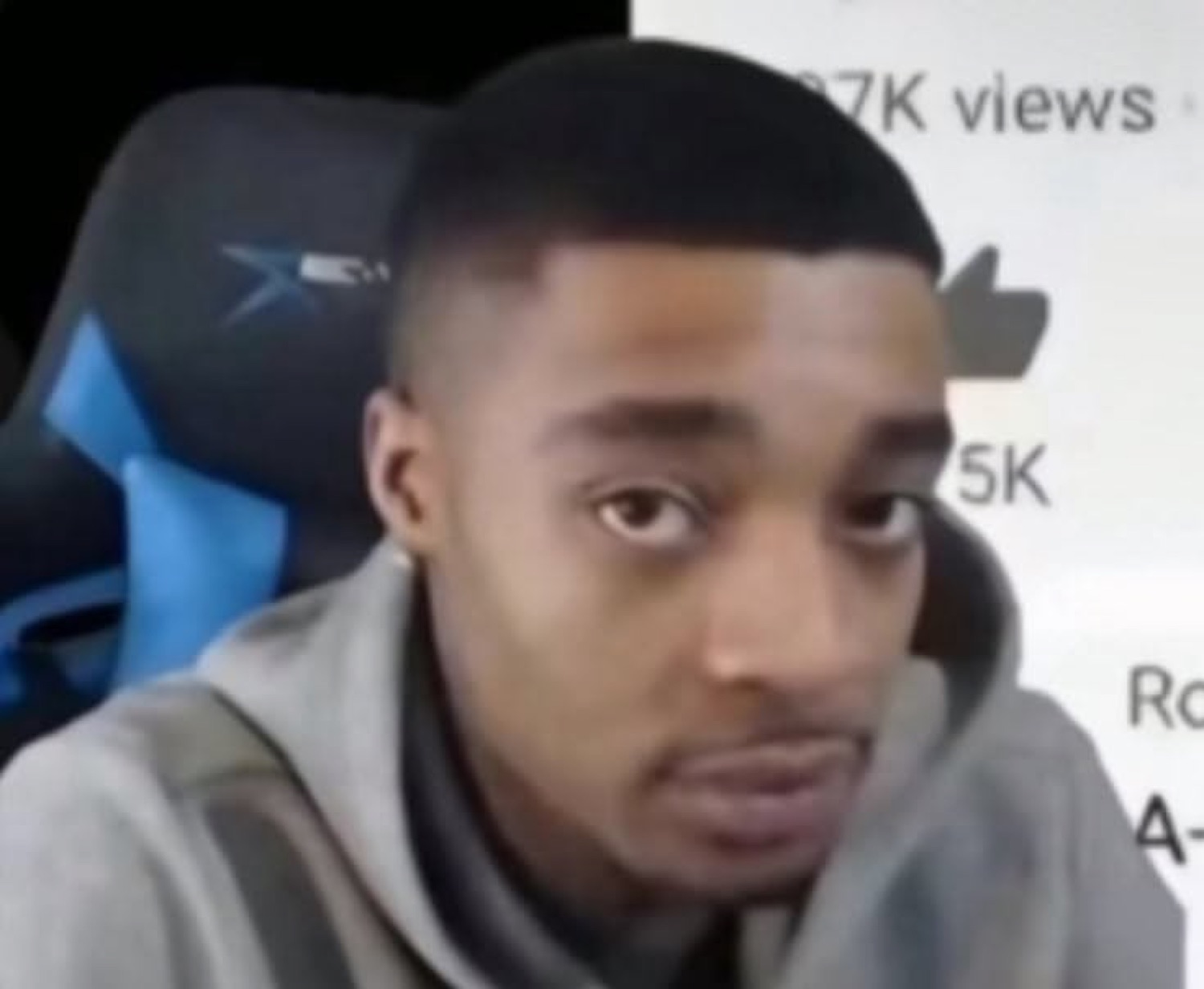 Guy sitting in a gaming chair giving the flattest, most unimpressed stare
