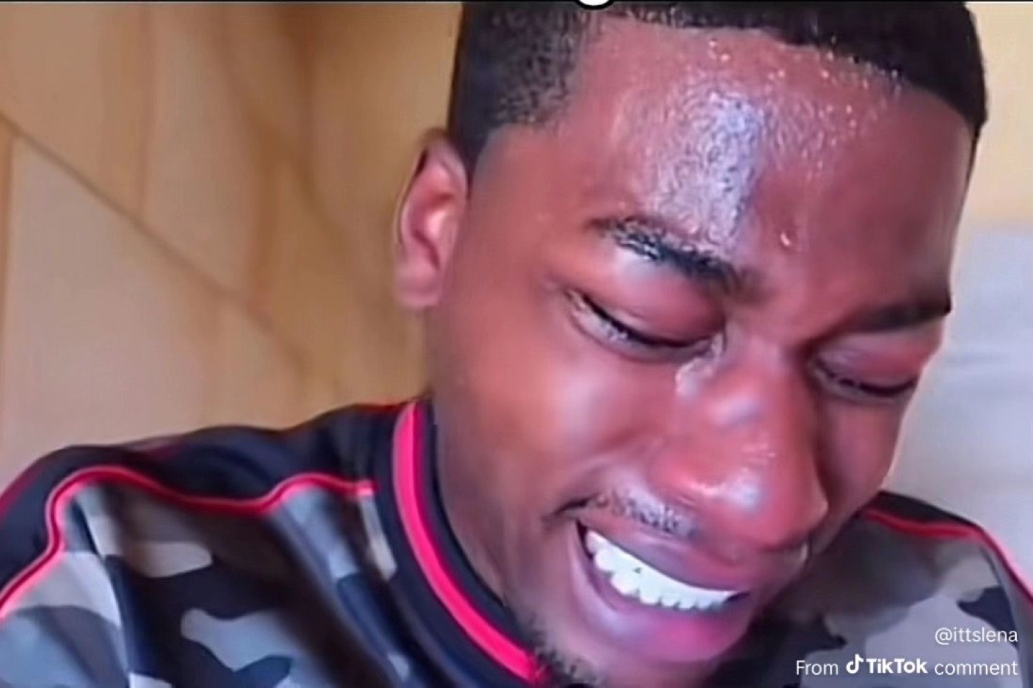 Man breaking down in tears with a shaky, sweaty grin