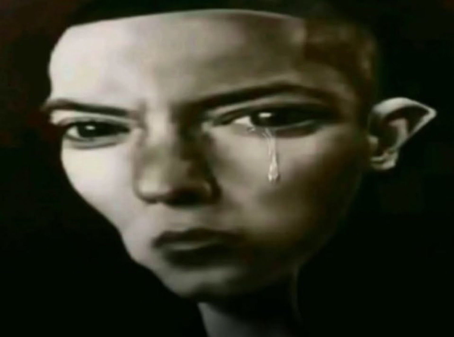 Painted bald figure with a single tear rolling down and a hard, sorrowful stare