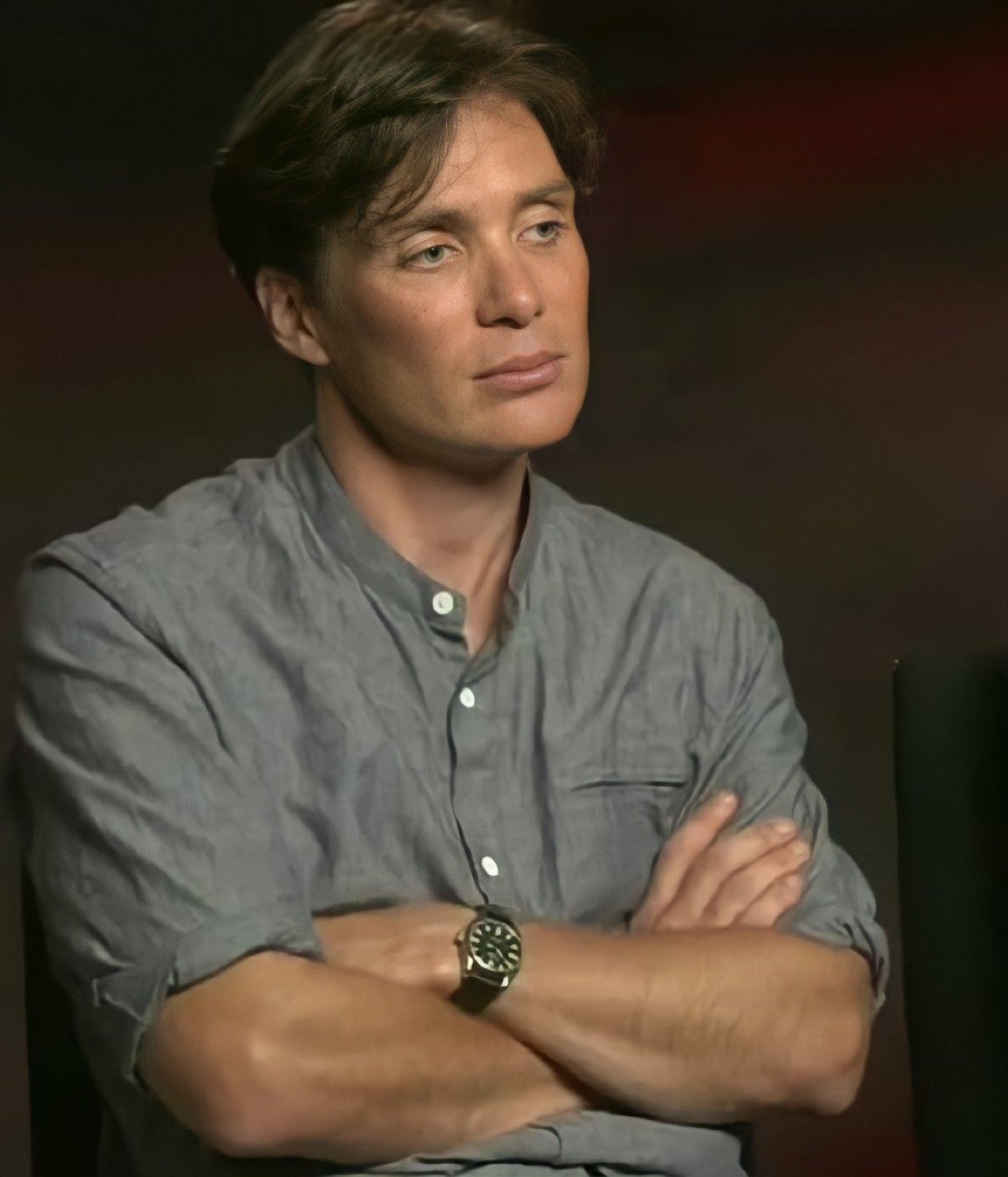 Cillian Murphy sitting with arms crossed, giving a thoroughly unimpressed stare