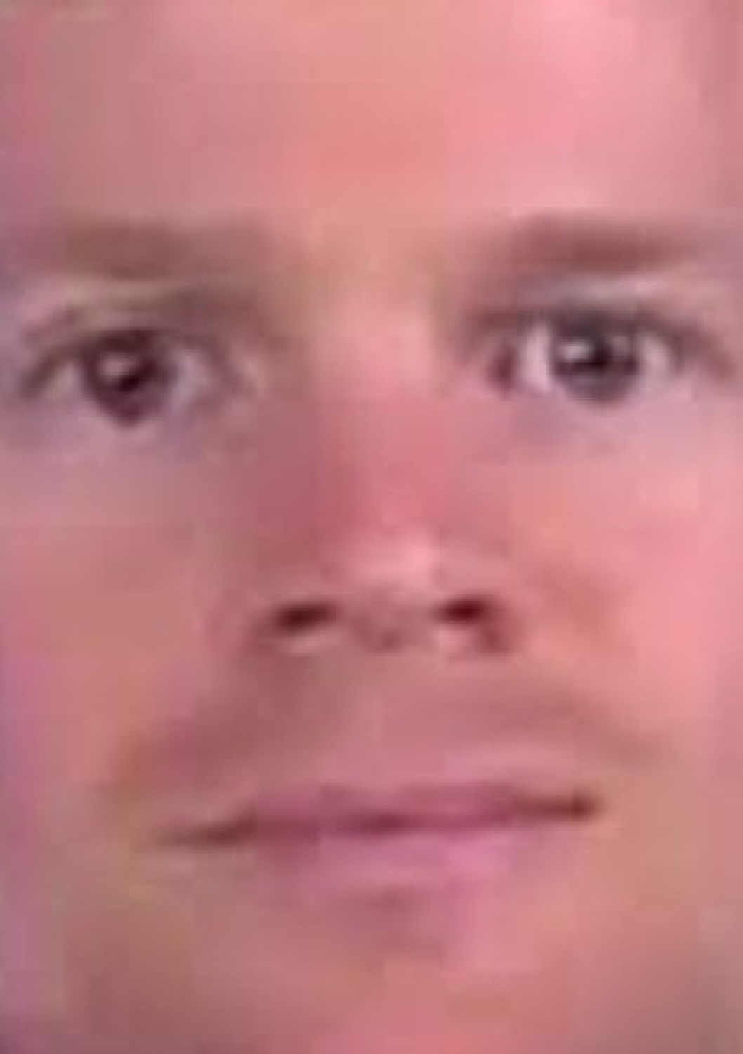 Blurry extreme close-up of a man's face with a flat, blank stare