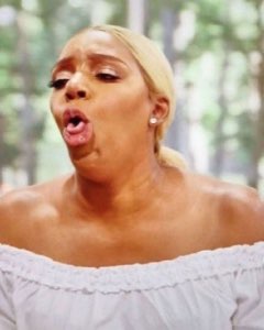 Woman outdoors with mouth agape in a dramatic, appalled reaction