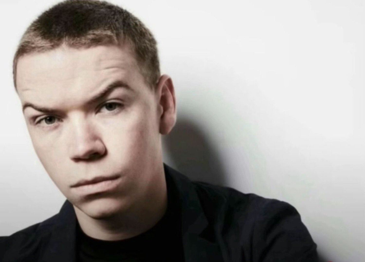 Young man in a black shirt giving an intense, dead-serious glare at the camera