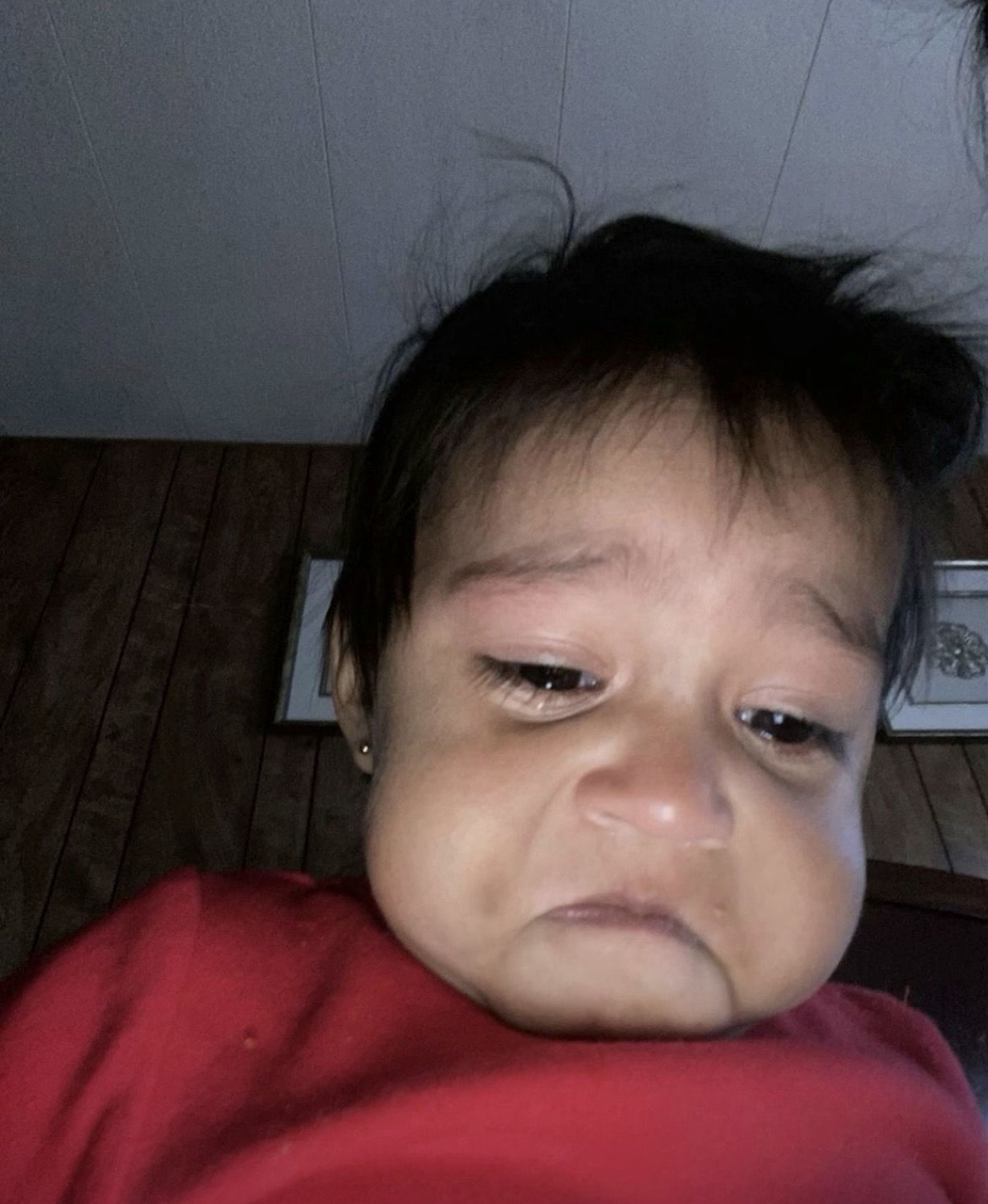 Baby with a droopy, deeply unimpressed frown that says they're already done with today