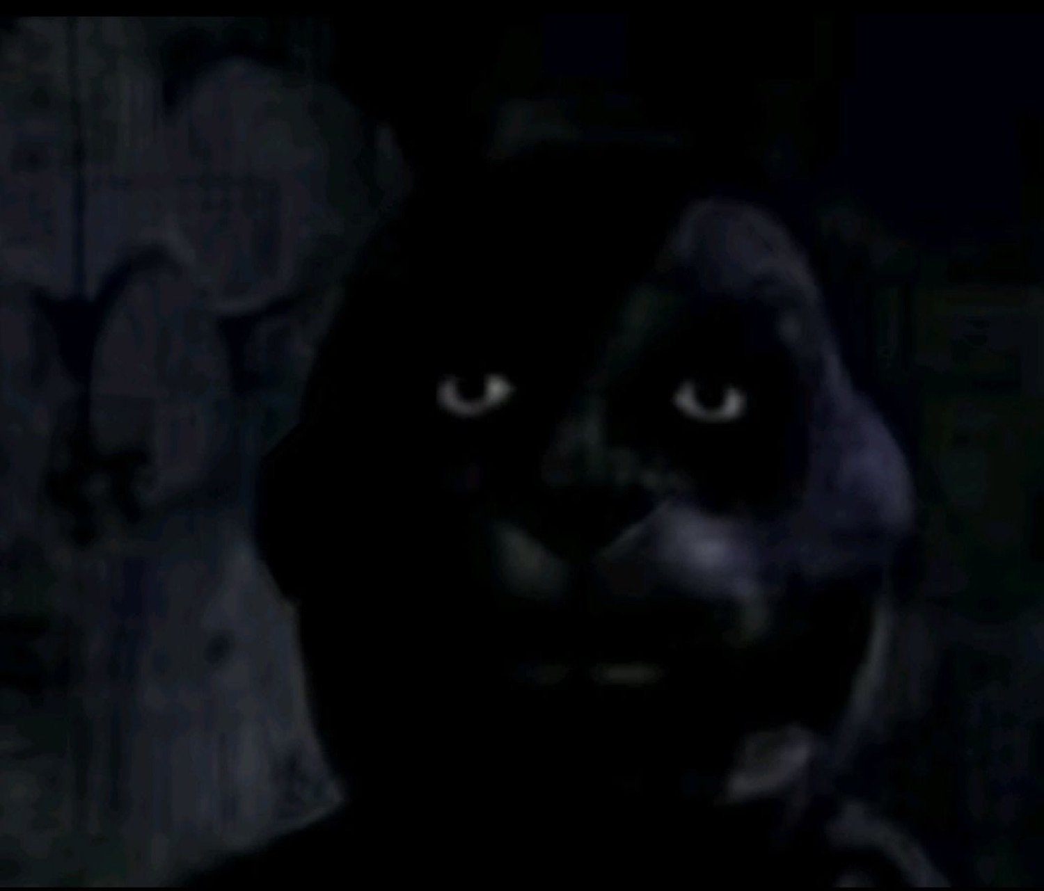 Shadowy animatronic bunny face lit only by two glaring eyes in the dark