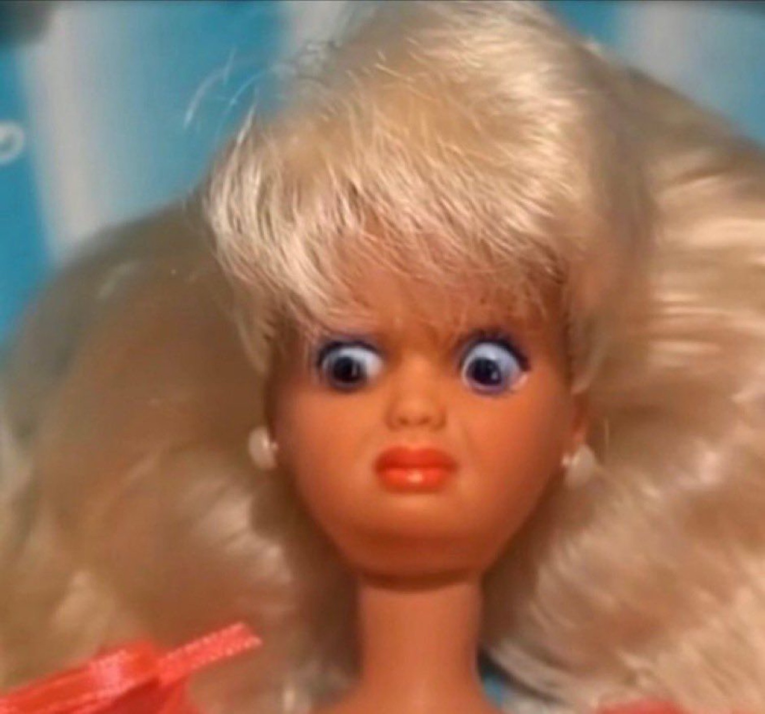 Barbie doll with a deeply unsettling wide-eyed expression and pursed lips