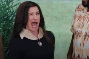 Kathryn Hahn winking with a giant open-mouthed grin of glee