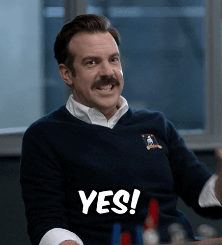 Jason Sudeikis as Ted Lasso pointing and shouting "Yes!"