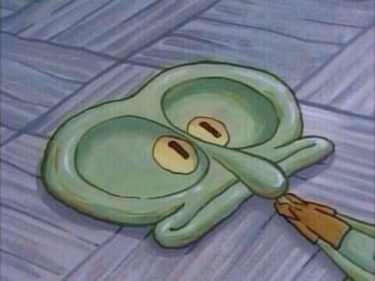 Squidward lying flat and squashed on the floor with a blank face