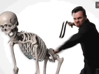 Man dancing alongside a skeleton
