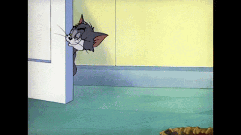 Tom from Tom and Jerry peeking around a door sticking his tongue out