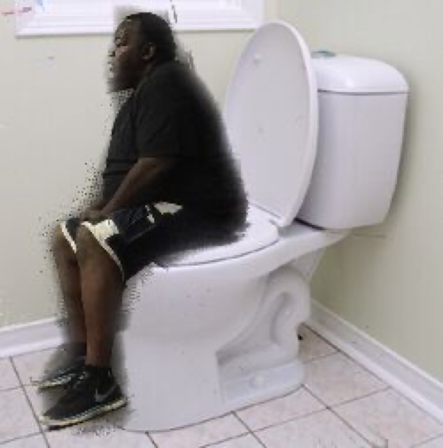 Man on a toilet dissolving into pixels