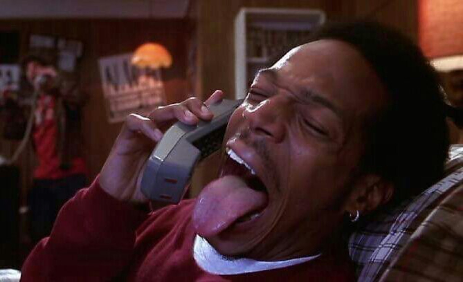 Man screaming 'wassup' on the phone with his tongue out
