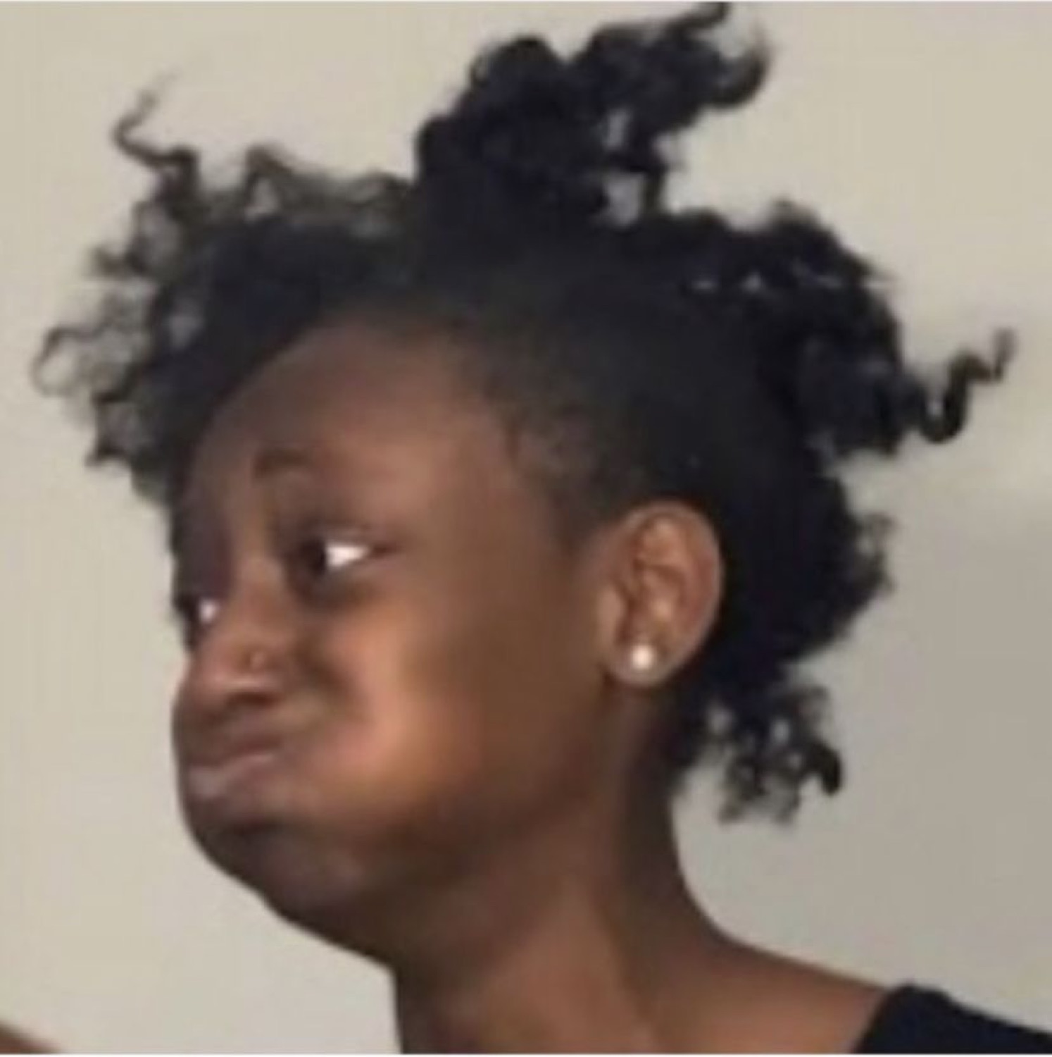 Girl with wild bed hair pouting sideways