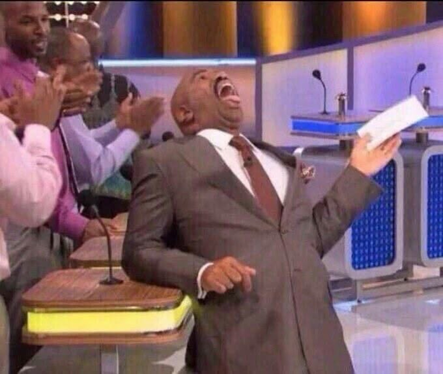 Steve Harvey laughing and celebrating on Family Feud