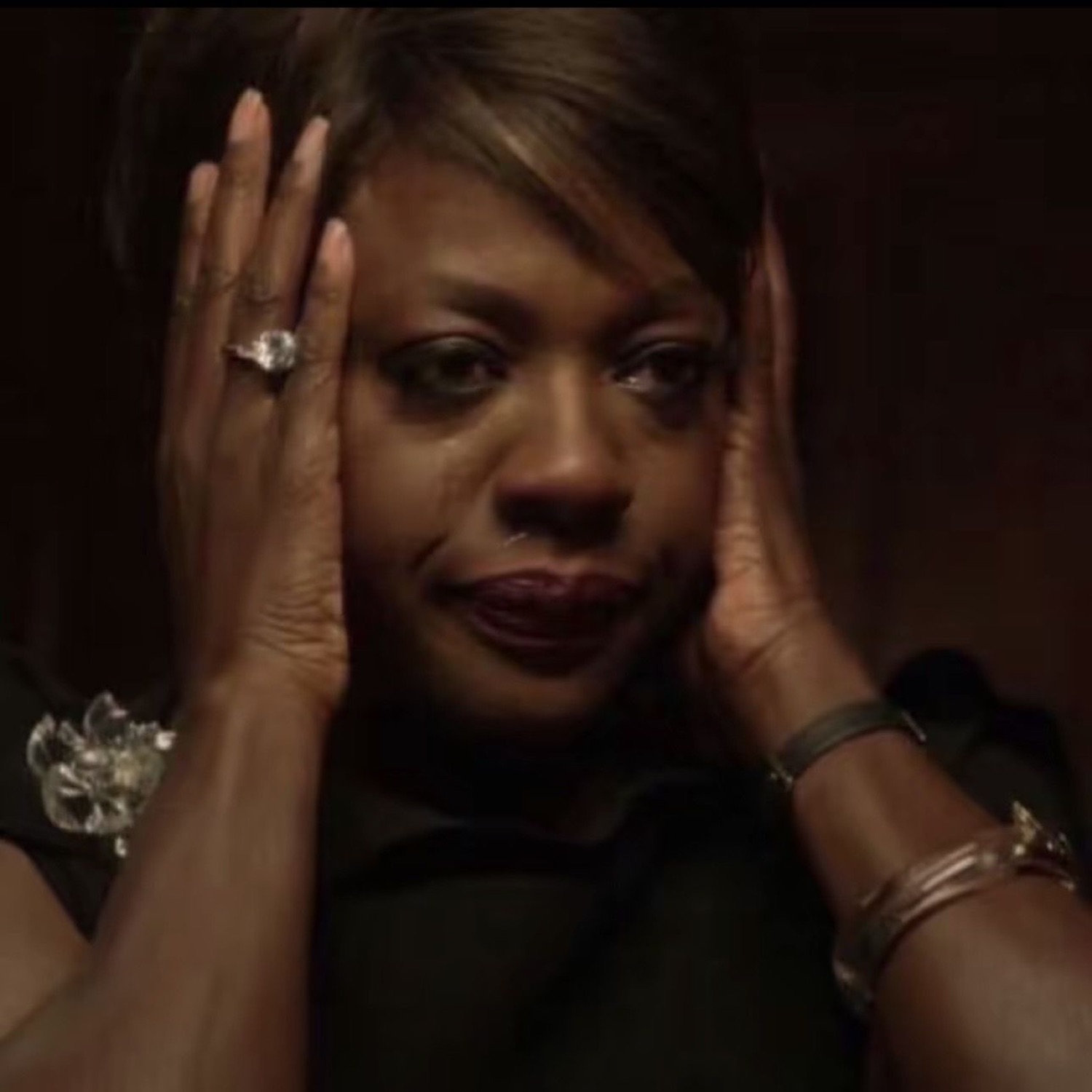 Viola Davis pressing her hands to her head with a stunned, hurt stare
