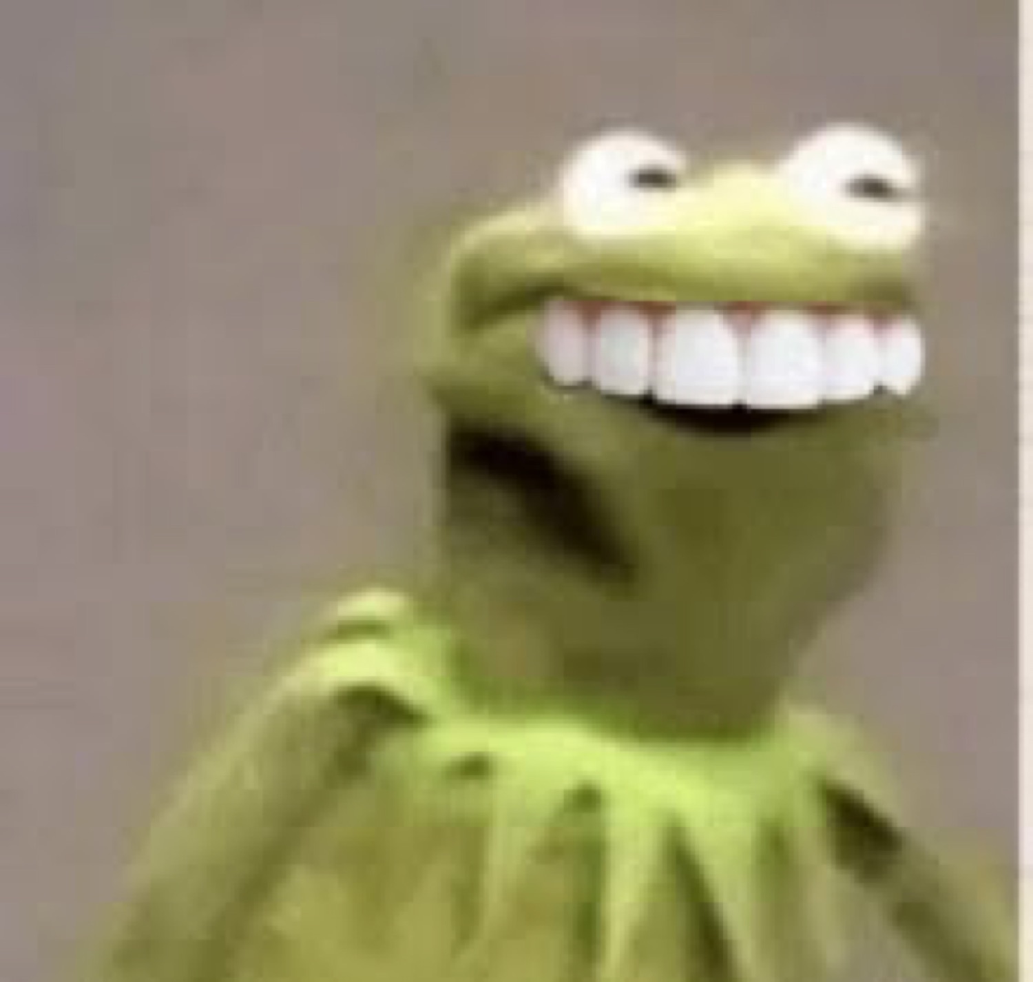 Kermit the Frog grinning with an unsettlingly wide smile and mischievous look