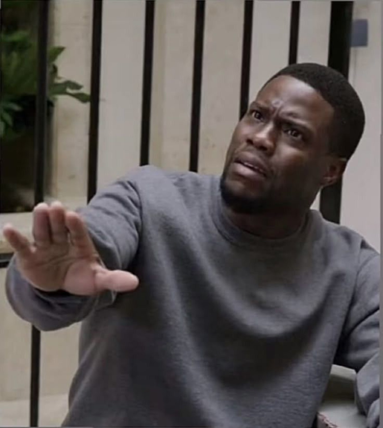 Kevin Hart reaching out with a confused, exasperated 'what do you want from me' expression