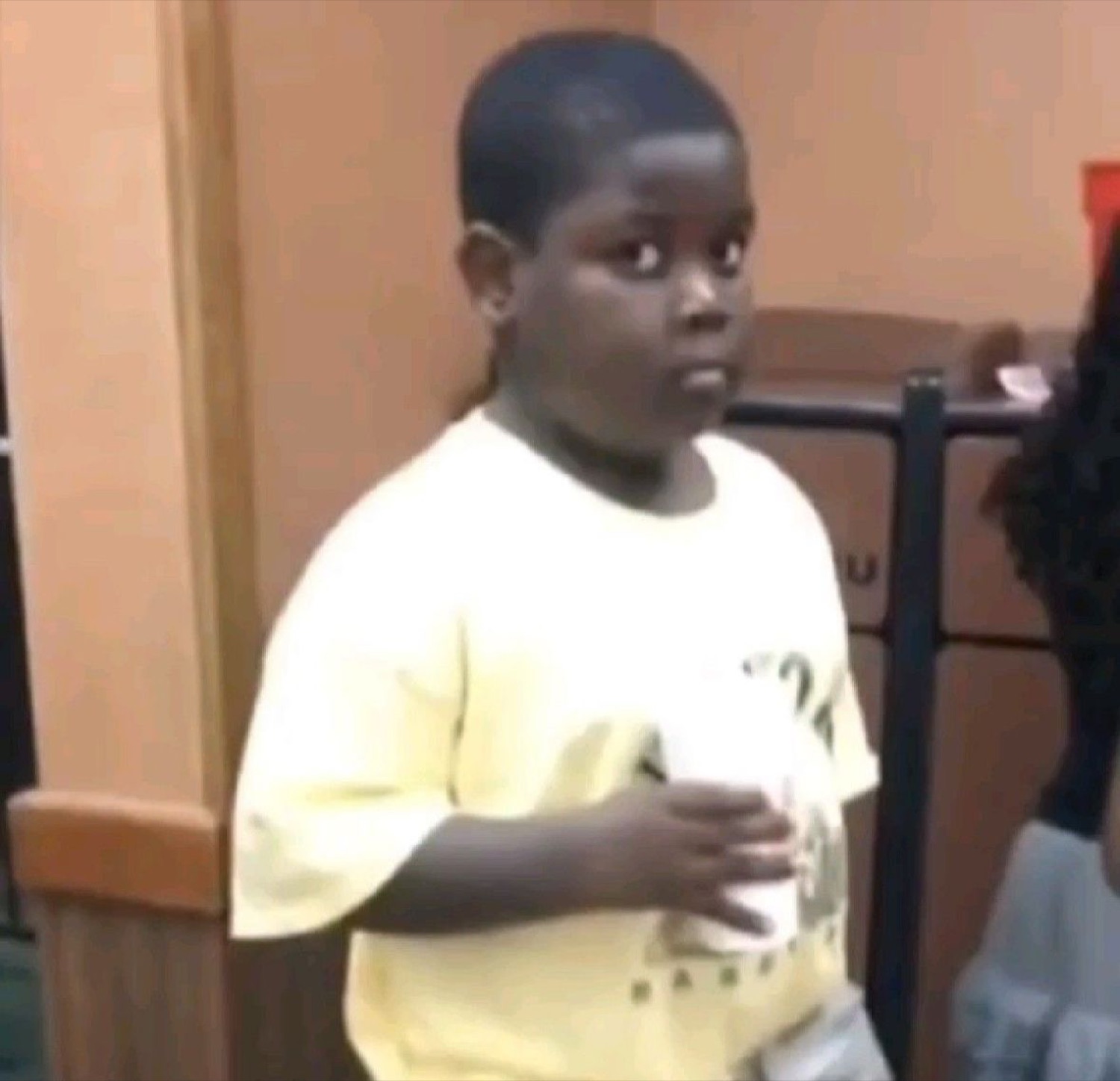 Kid in a yellow shirt frozen mid-step with a wide-eyed 'oh no' expression