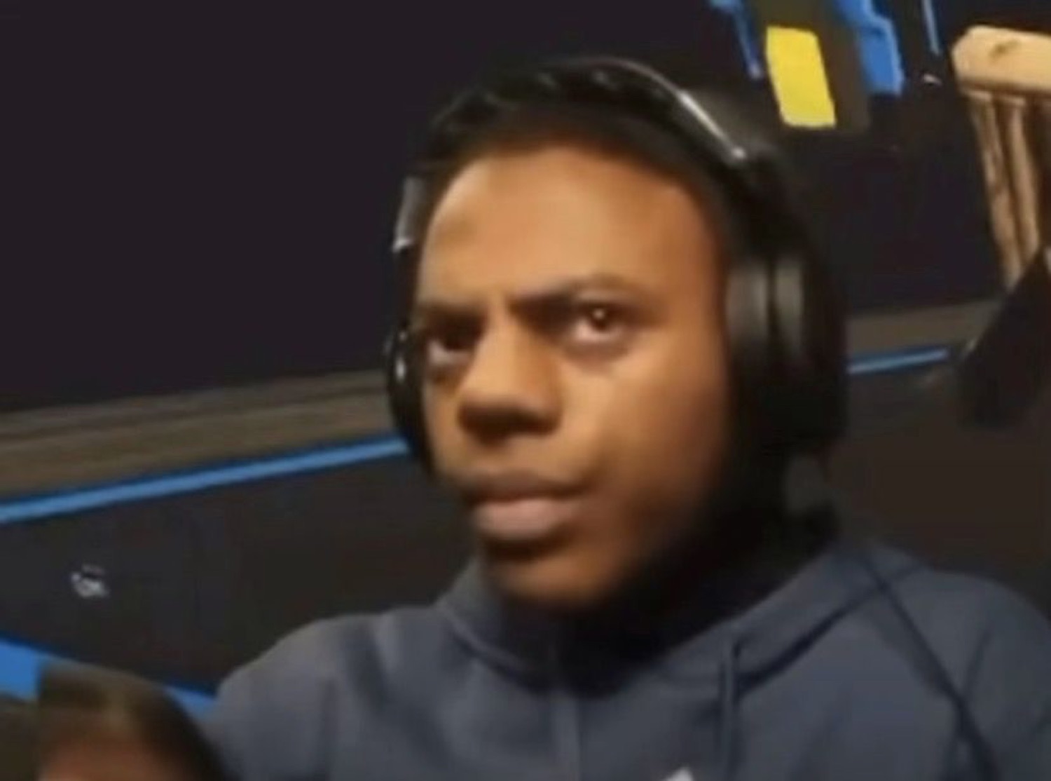 Guy in gaming headphones frowning at his screen, thoroughly confused