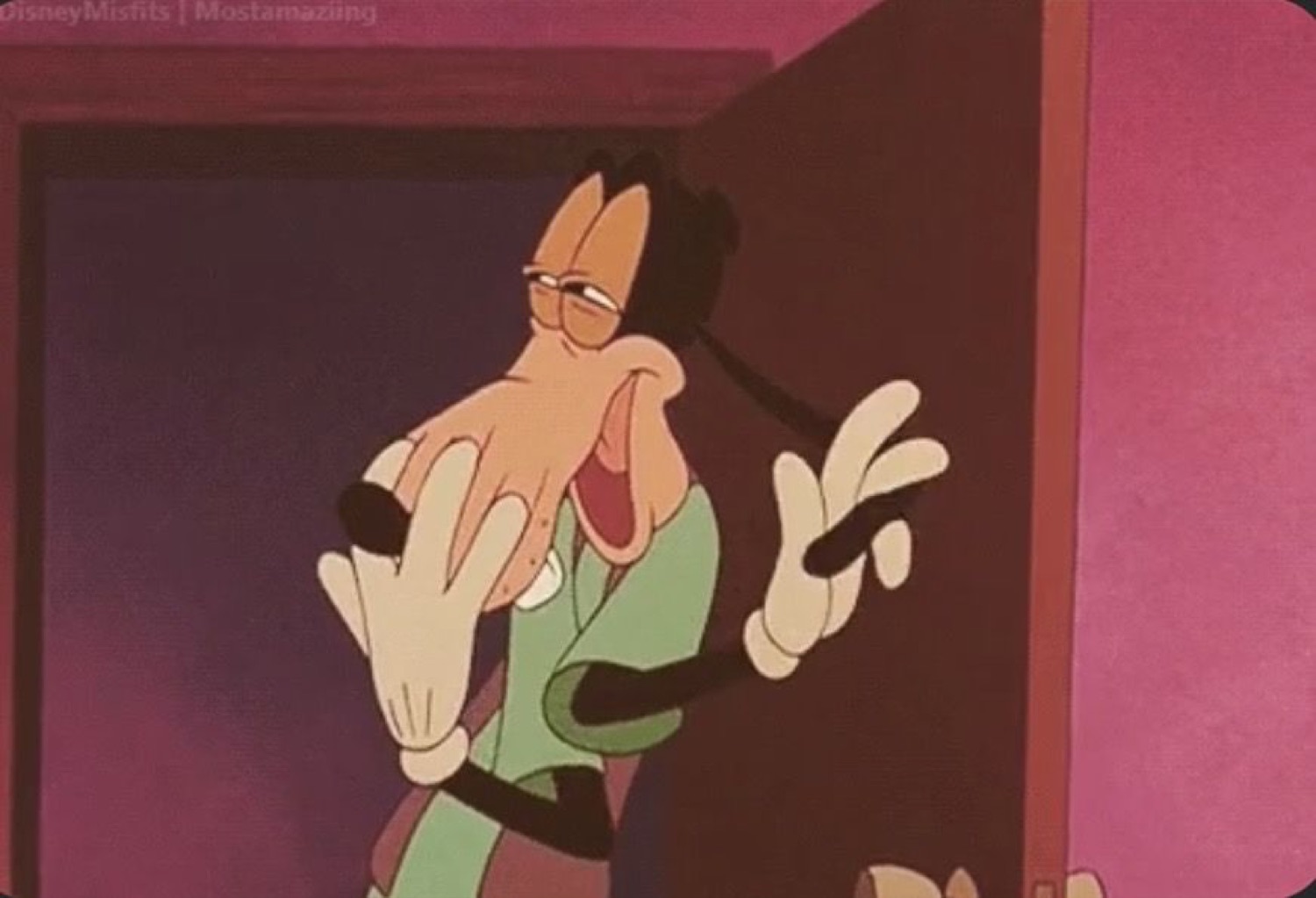Goofy leaning in doorway with a goofy grin and jazz-hands energy