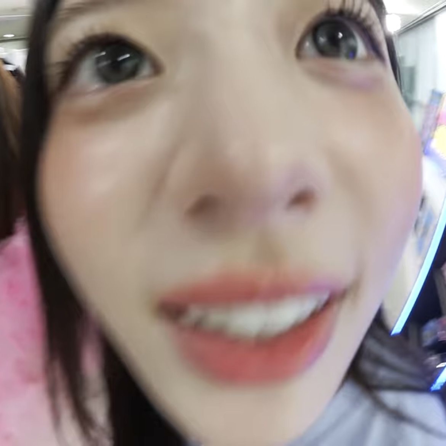 Extreme close-up selfie of a girl grinning right into the camera lens