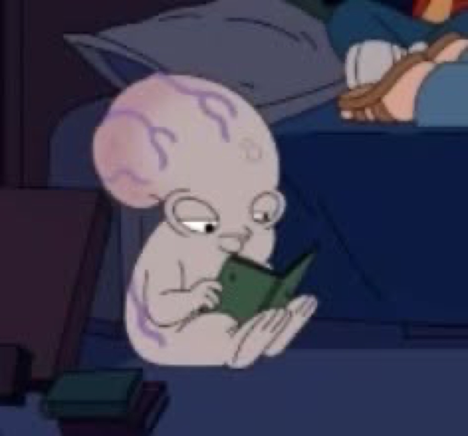 Wrinkly cartoon alien-baby reading a tiny book with a tired, deadpan look