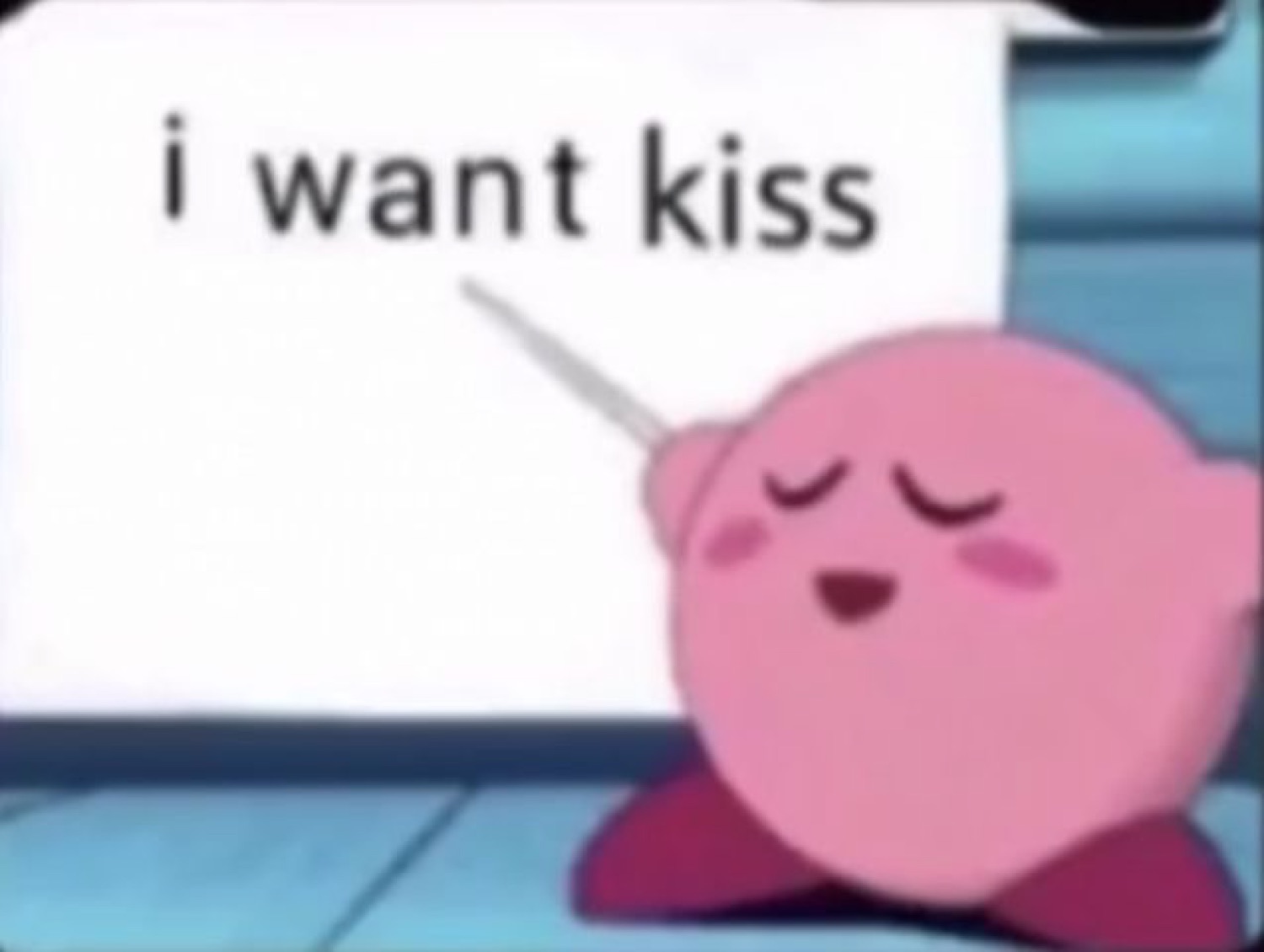 Kirby sitting with eyes closed and a blush, holding a sign that says 'i want kiss'
