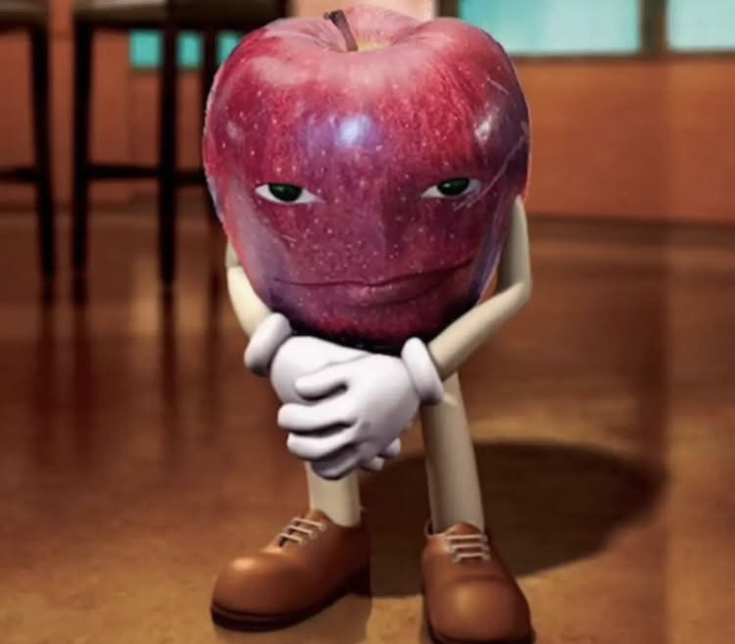 CGI apple character sitting hunched over with a deeply brooding, unimpressed face