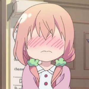 Pink-haired anime girl with red blush stripes across her eyes, head bowed in embarrassment