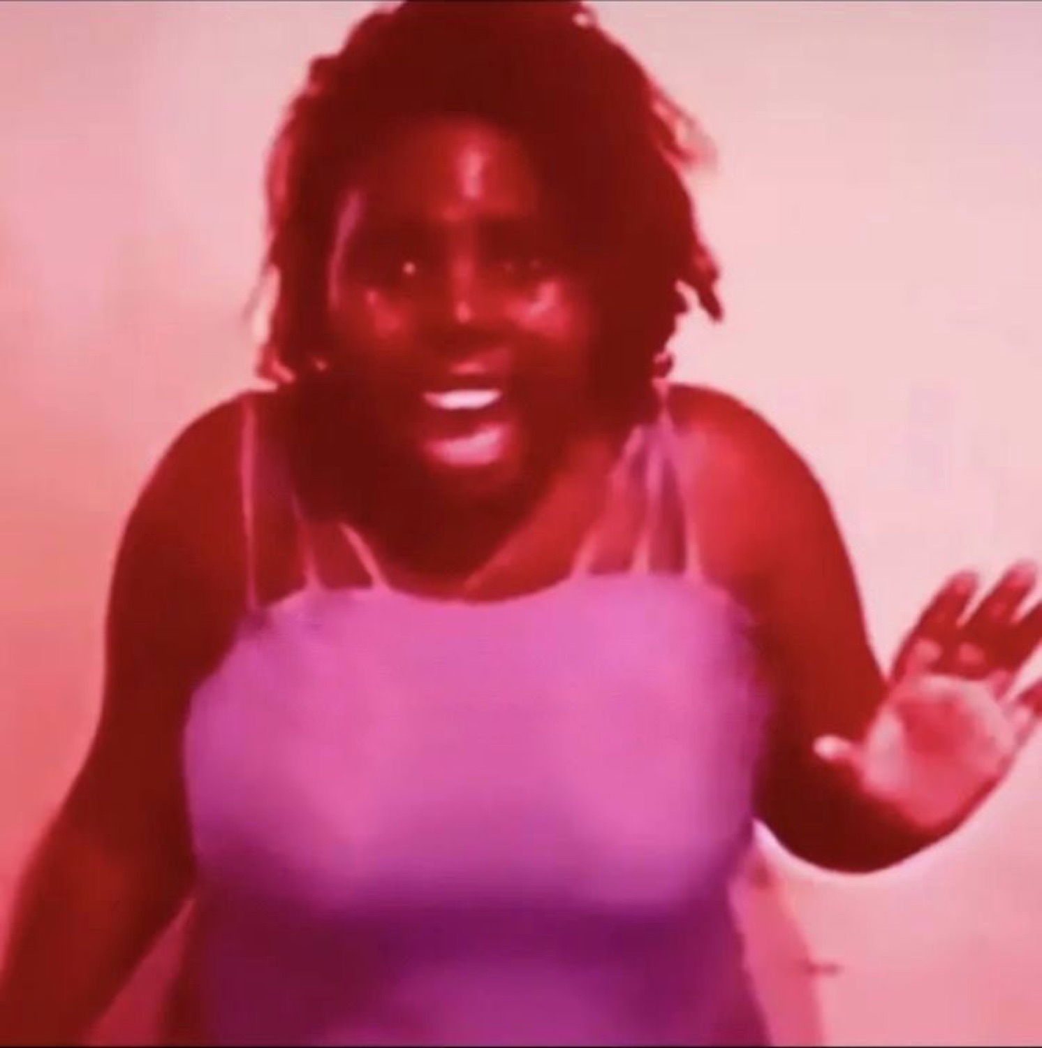Woman with a red color-filtered photo, smiling big and waving