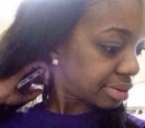 Woman glancing down with a flat, unfazed expression while holding a phone to her ear