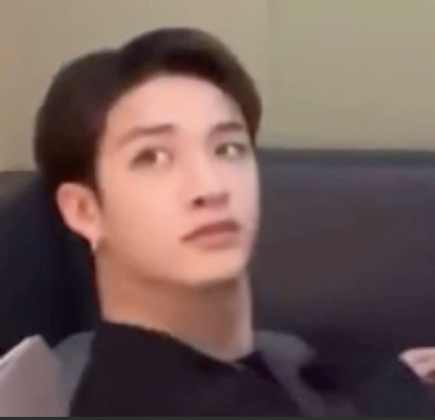 Young Asian man tilting his head back with an eye-roll expression